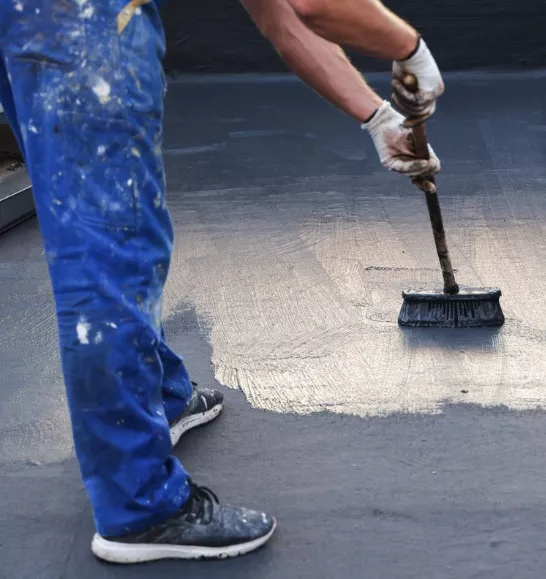 Crew applying commercial roof coatings on a flat commercial roof in Illinois