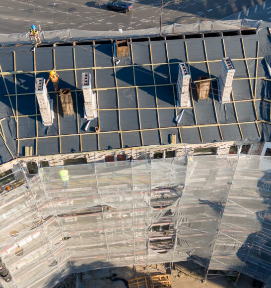 Commercial roofer in Peoria Illinois evaluating membrane seams and drainage performance