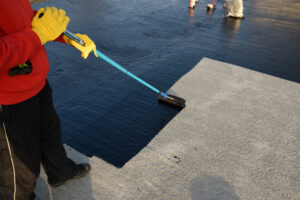 A member of Big River Roofing, roofing contractors Galesburg IL trusts, waterproofs a roof
