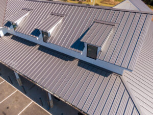 Drone aerial photos showcasing commercial buildings with sleek standing seam metal roofs. Big River Roofing and Coatings are roofing contractors in Peoria IL
